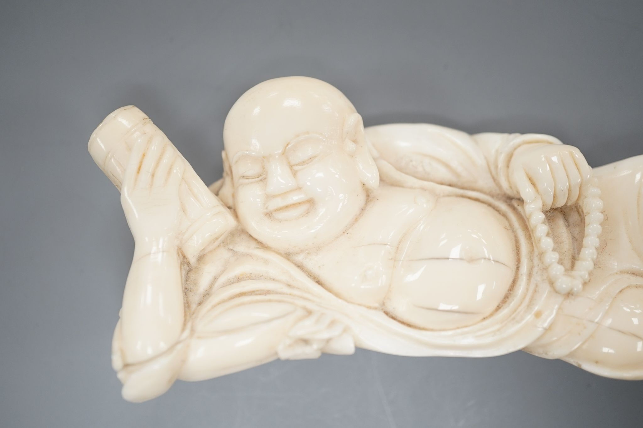 A 19th century Chinese carved ivory figure of Budai 11cm